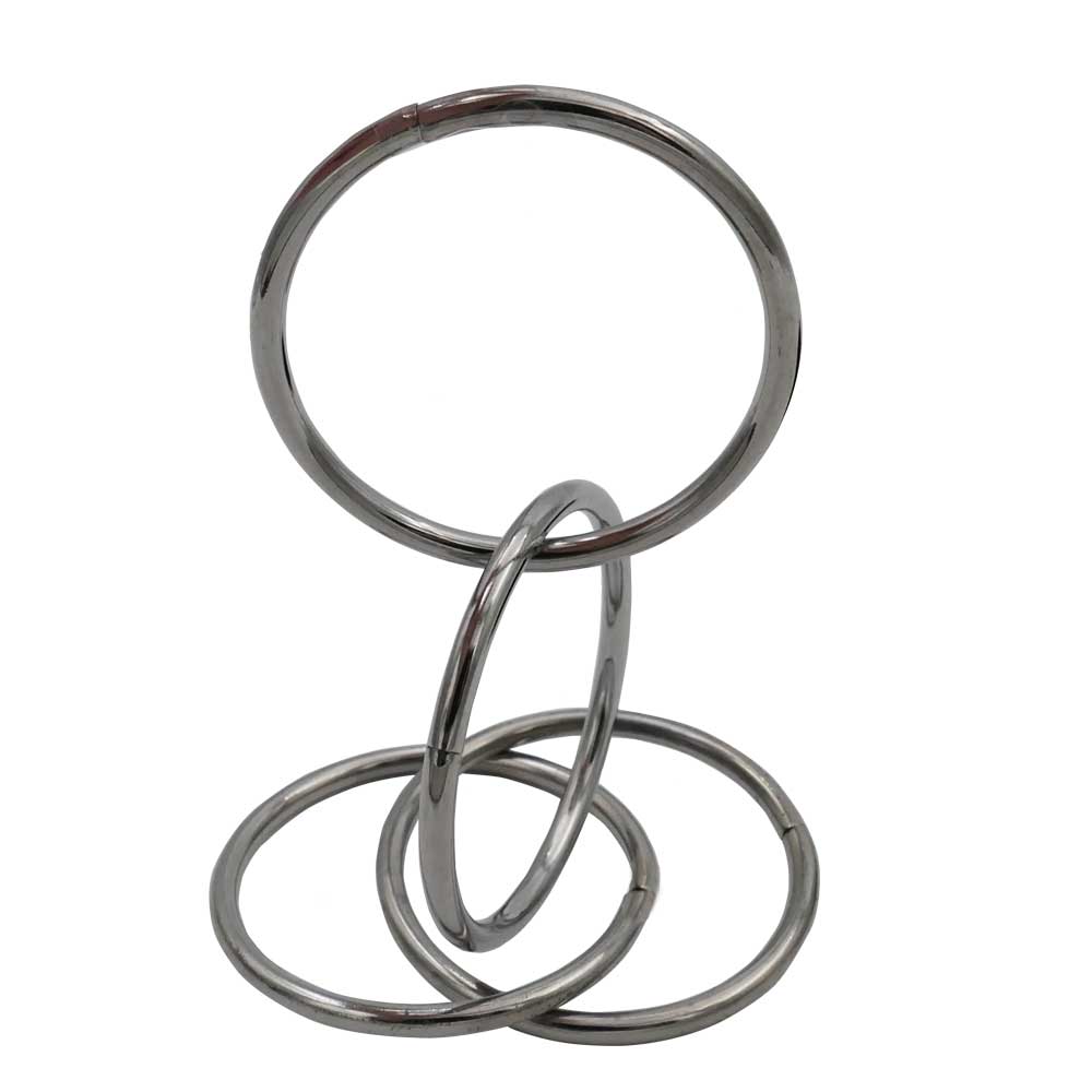 Shiny pocket-sized Linking Rings set with four polished metal rings and a black carrying pouch for magical performances.