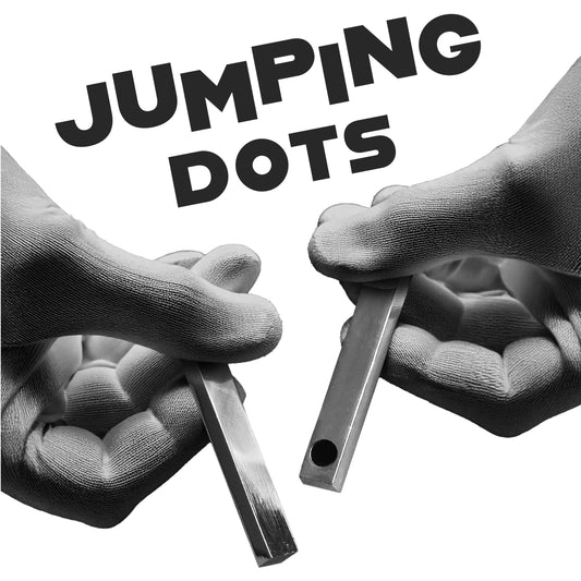 Two sleek metal paddles with colorful enamel dots, showcasing the magical Jumping Dots trick for captivating illusions.