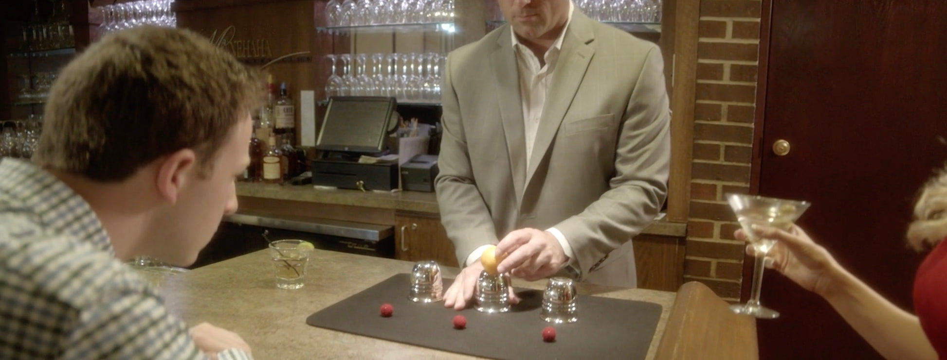Shiny chrome Cups and Balls set for professional magicians, featuring three heavy, polished cups and colorful knit balls.