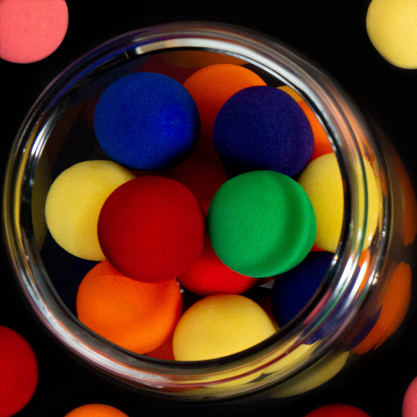 Vibrant 7-color sponge ball set with 4 soft, 2-inch Pro Grip balls per pack, displayed in a sleek black window box.