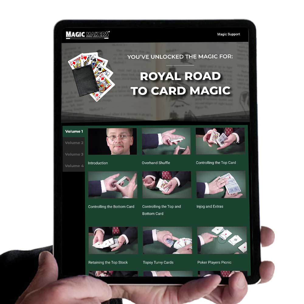 Detailed view of the Royal Road to Card Magic Kit, featuring a vibrant red-backed De Land's marked deck and instructional materials.