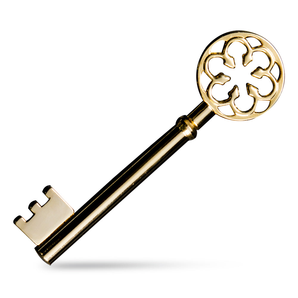 Stunning gold-plated Magic Key with intricate teeth design, showcased on fingertips for a mesmerizing magic trick.