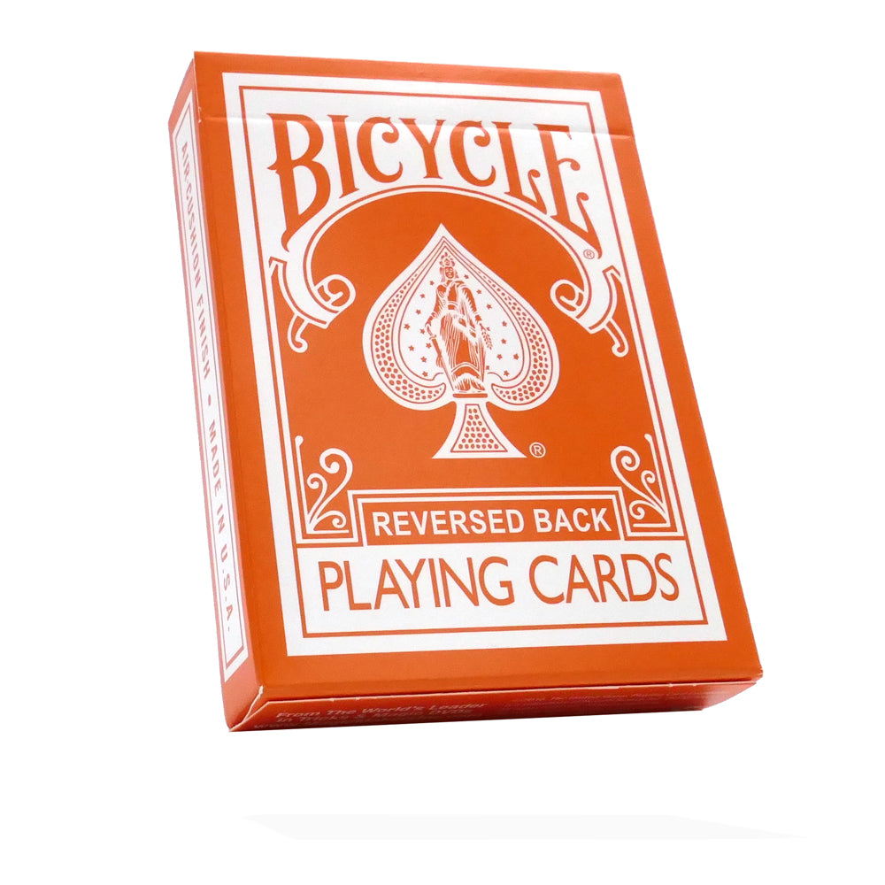 Vibrant orange Bicycle Back playing cards with a striking reversed white design on the back, perfect for card tricks.