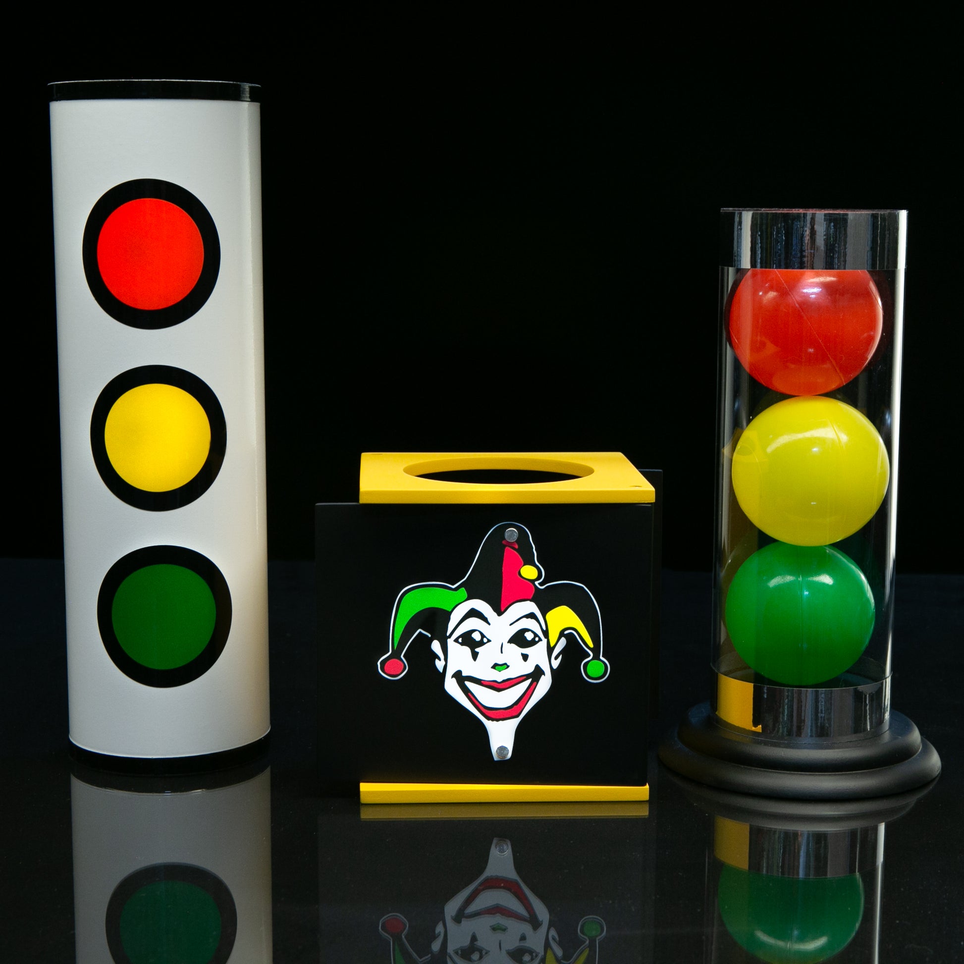 Vibrant Joker Tube set for magicians, featuring a crystal-clear tube, colorful red, yellow, and green balls, and a sturdy metal cover.