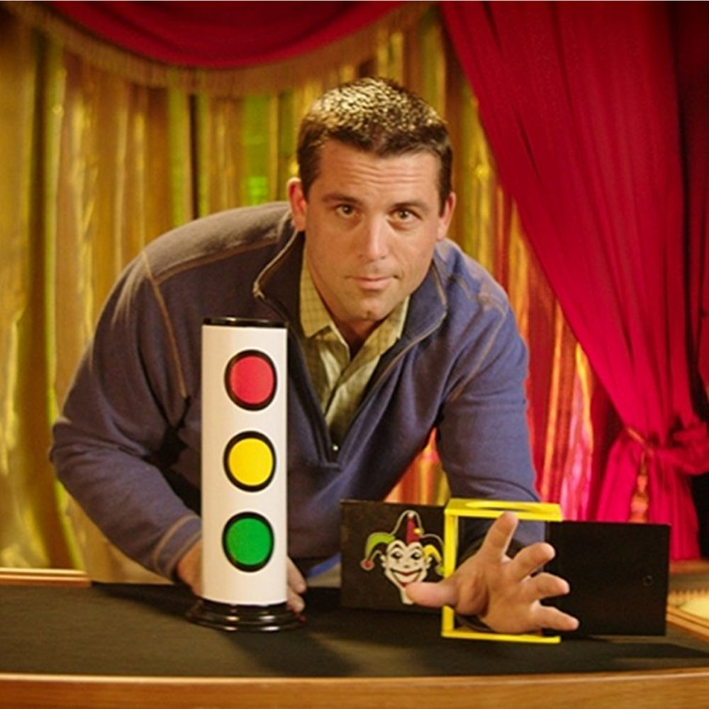 Vibrant Joker Tube set for magicians, featuring a crystal-clear tube, colorful red, yellow, and green balls, and a sturdy metal cover.