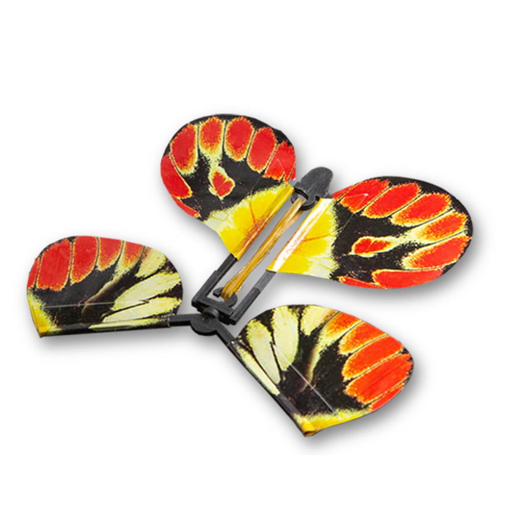 Vibrant monarch-patterned butterfly toy springing to life from a surprise card, ready to fly up to 20 feet in the air.