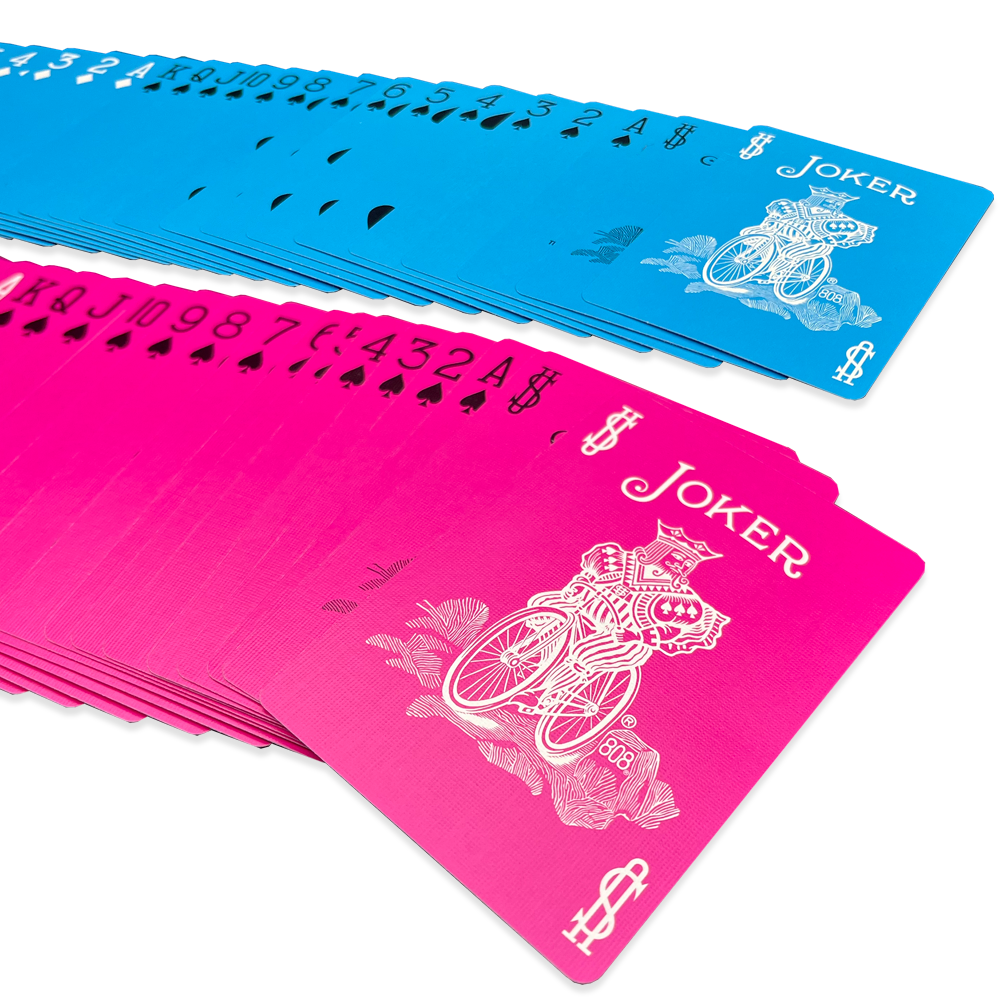 Vibrant pink and blue Bicycle playing cards in a 2-deck combo, showcasing colorful court cards with bold black and white pips.