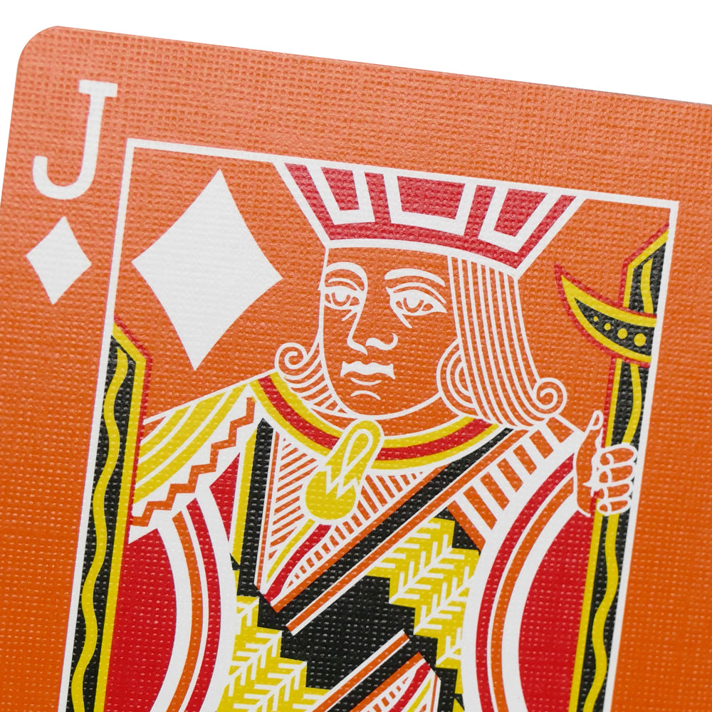 Vibrant orange Bicycle Back playing cards with a striking reversed white design, showcasing a bold and colorful deck.