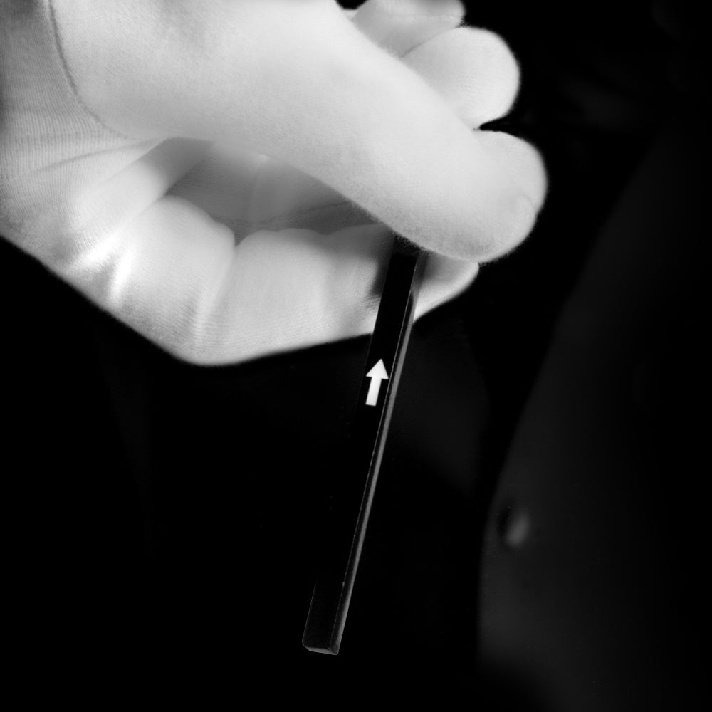Close-up of the Magic Arrow Stick by Magic Makers, showcasing a white arrow mysteriously moving along a sleek stick.
