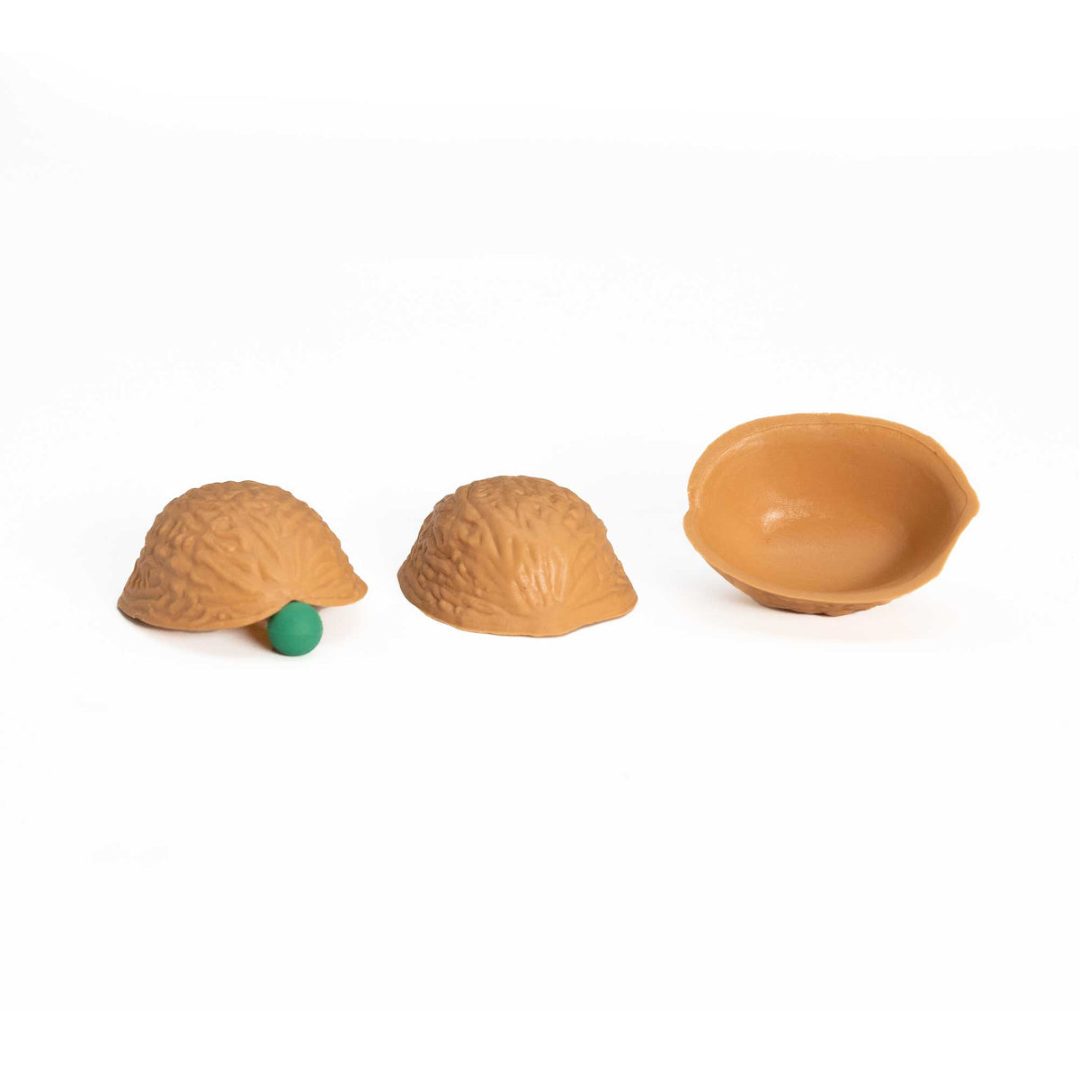 Three intricately molded walnut shells with a tacky pea, showcasing the Perfect 3 Shell Game set for seamless magic tricks.