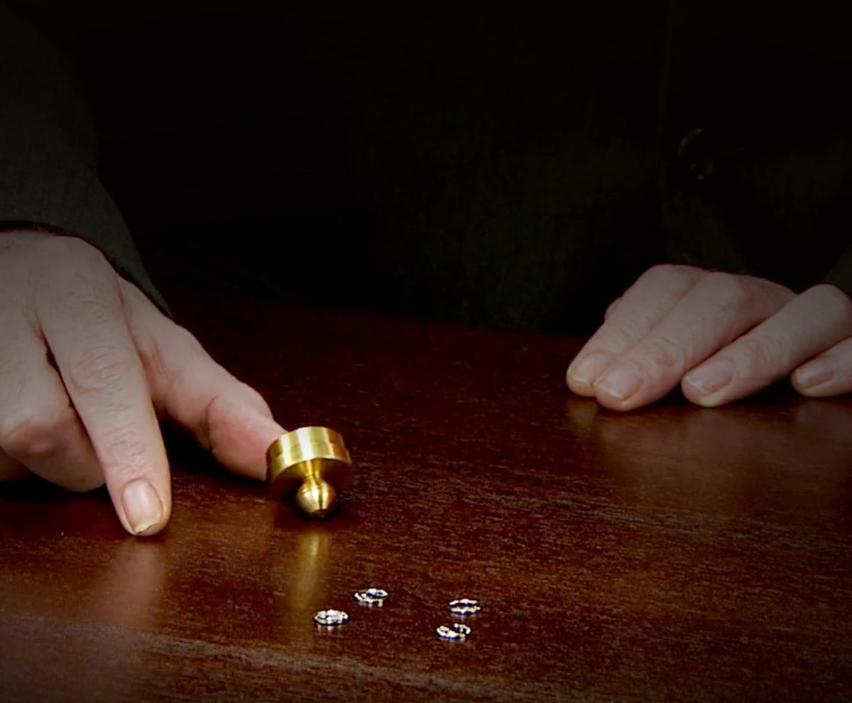 Magic Makers Magic Shrinking Nickels featuring a second close-up view of the brass cap and nickel stack for a mysterious and impressive close-up magic performance.