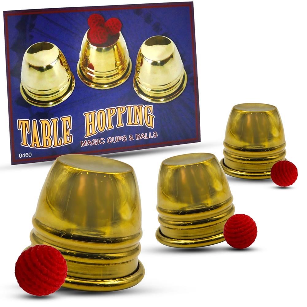 Gleaming set of 3 chrome Table Hopping Cups with 4 red crochet balls and rubber loads, perfect for mastering magic tricks.